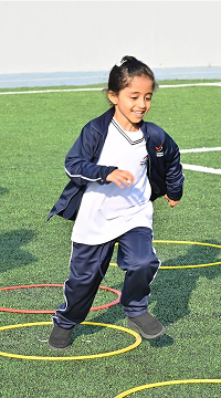 Student wearing PE uniform on sports field