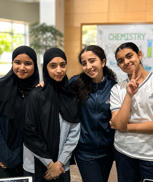Girls Division students smiling together at school