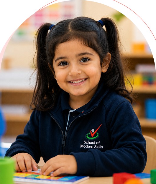 Young School of Modern Skills student smiling in class